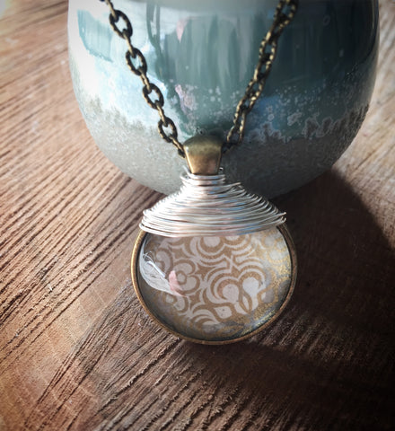 Cream and gold vintage style pendant on an antique bronze Long chain.