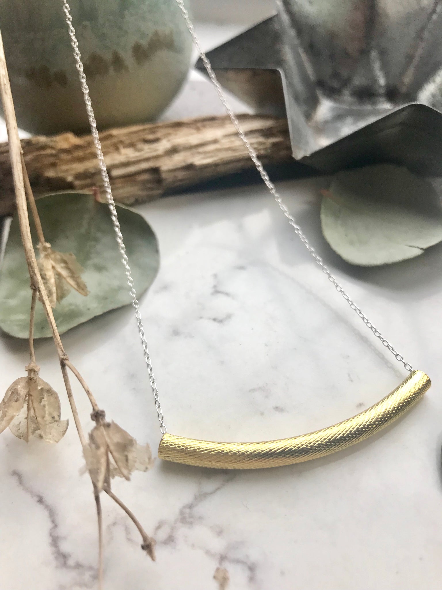 Gold and silver bar necklace.